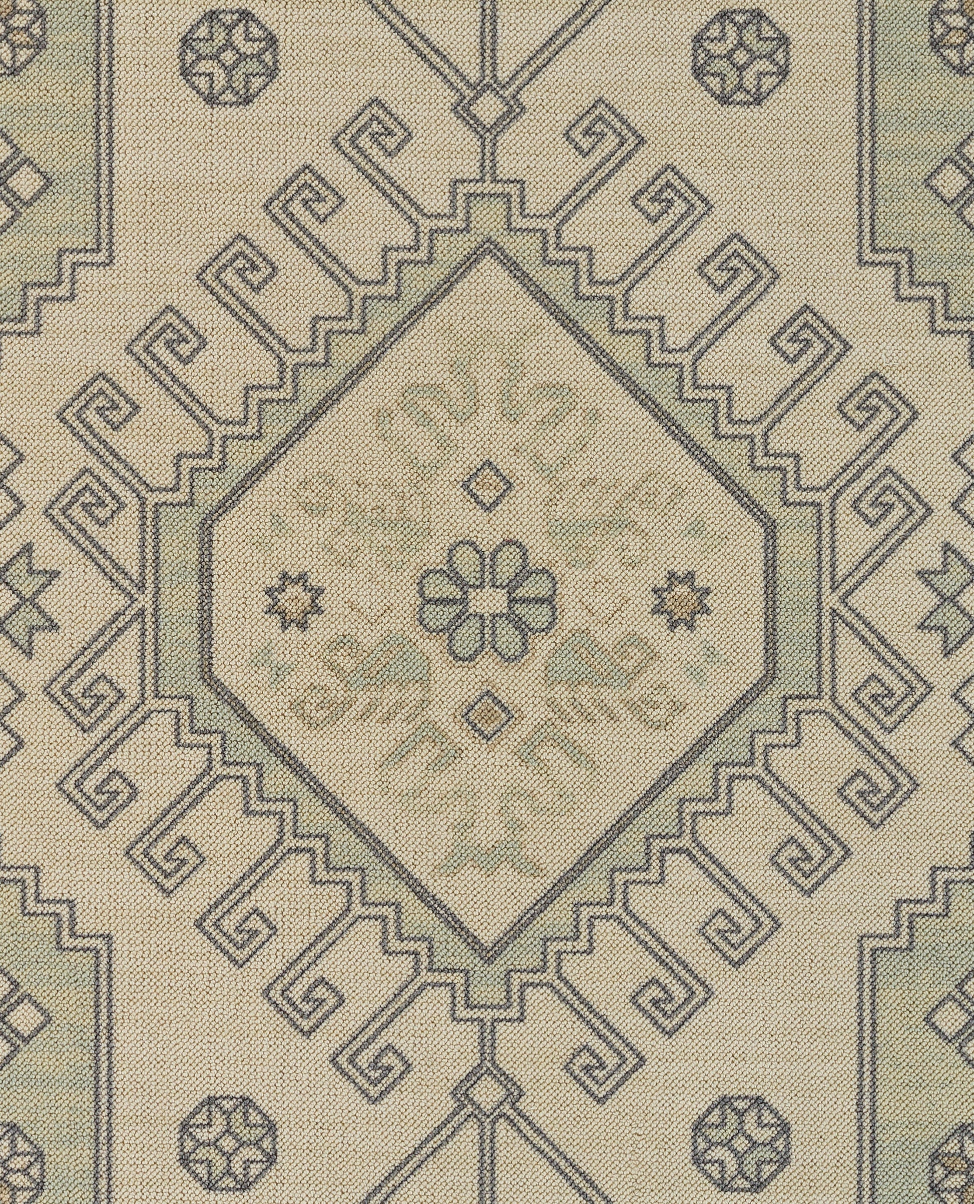 Cream woven rug with blue geometric diamond medallion and Greek key border, oriental-inspired decor