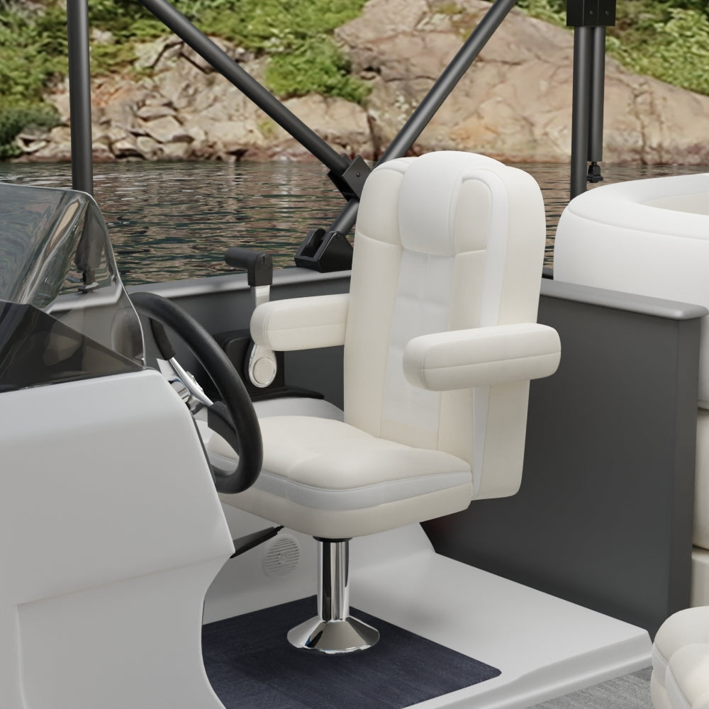 White captain chair with armrests on a chrome pedestal in a boat cockpit; steering wheel, water & rocky shore visible behind.