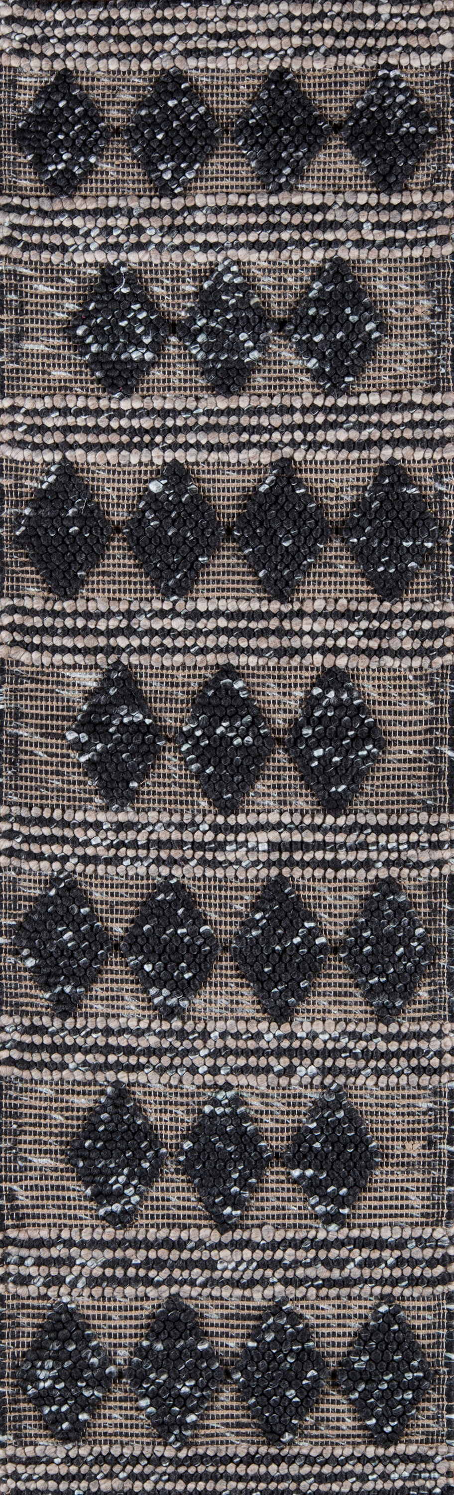 Woven rug runner with tan-beige base and black diamond motifs arranged in stacked rows; rustic boho pattern.