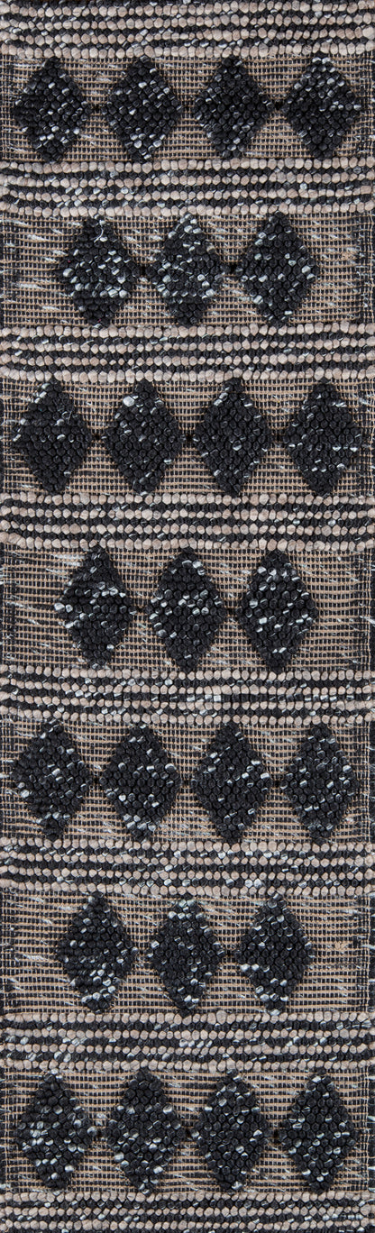 Woven rug runner with tan-beige base and black diamond motifs arranged in stacked rows; rustic boho pattern.