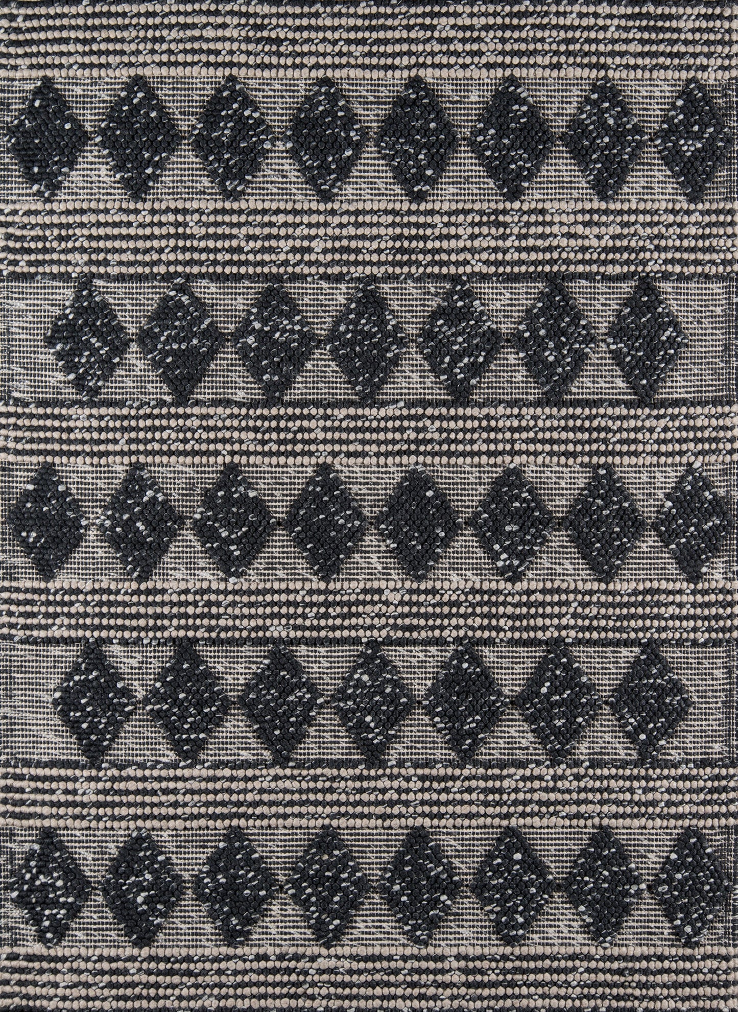 Geometric woven rug with black diamond motifs on beige background; bold tribal pattern and textured weave.