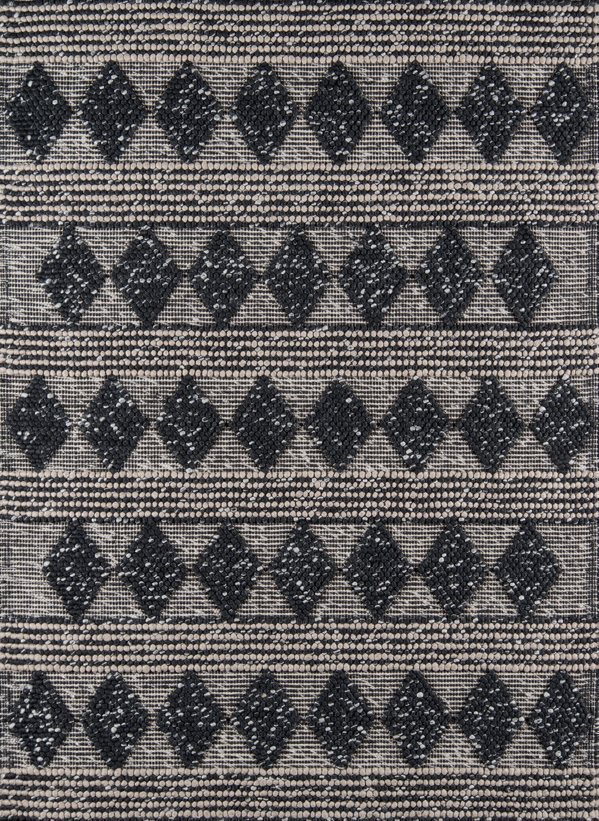 Beige woven rug with repeating black diamond motifs and dotted striped borders.