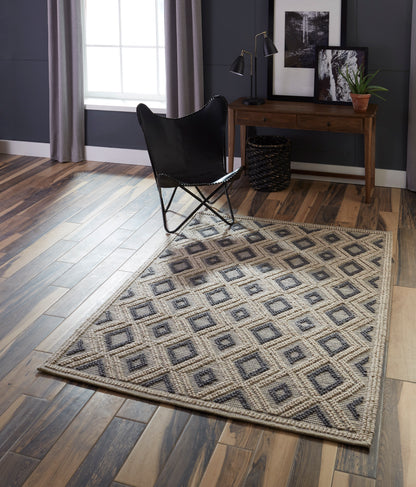 Rectangular woven rug with beige, gray and charcoal diamond pattern; flat-weave, textured, ideal for living rooms.