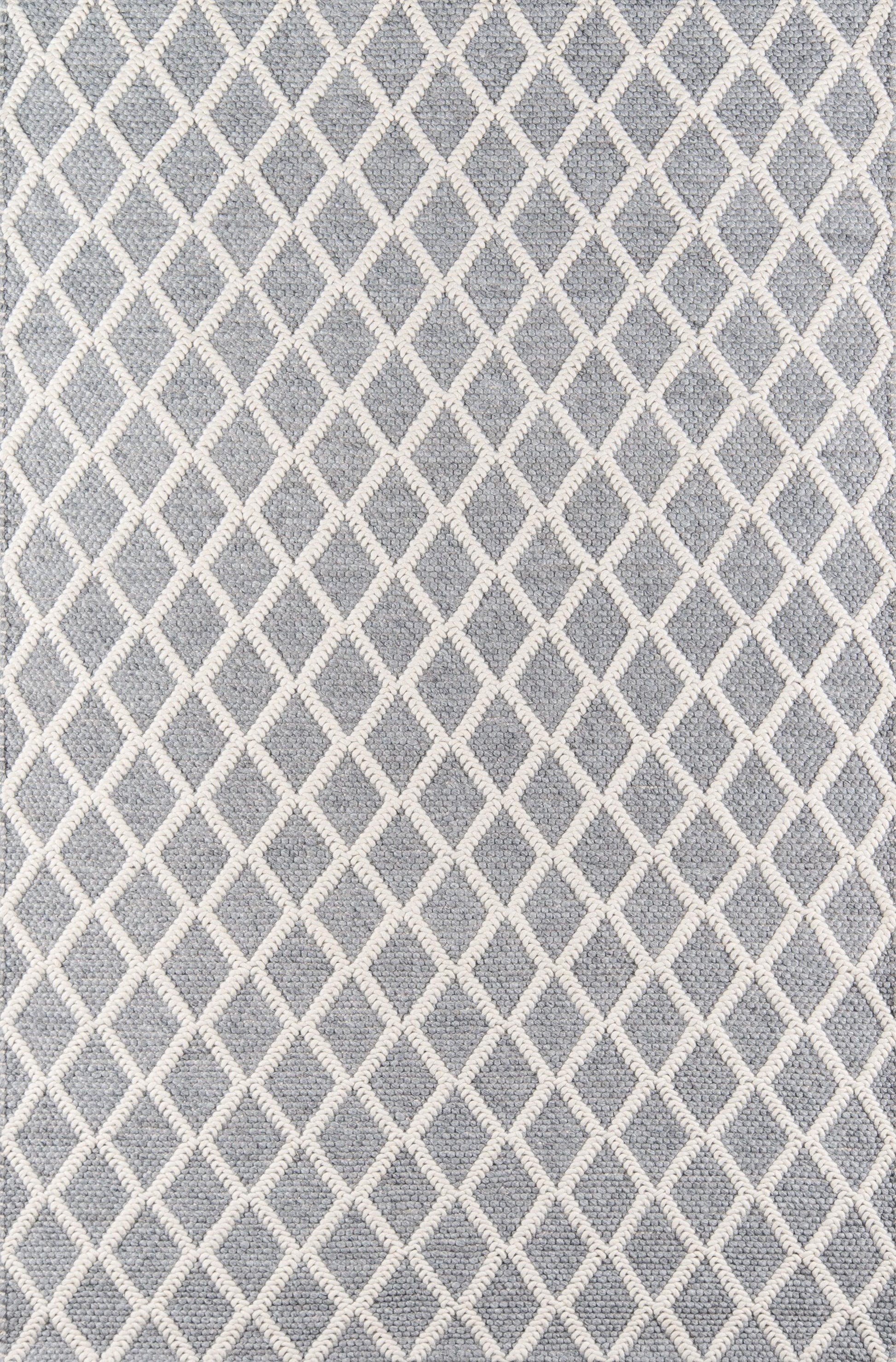 Gray rug with ivory diamond lattice pattern and soft textured weave.