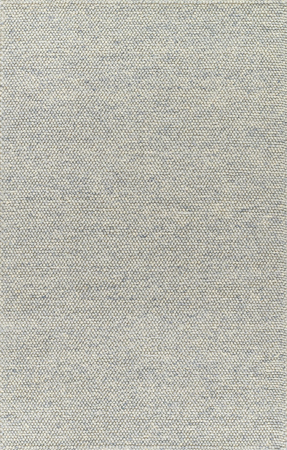 Beige rug with a tiny grey-blue pebble pattern; close-up texture.