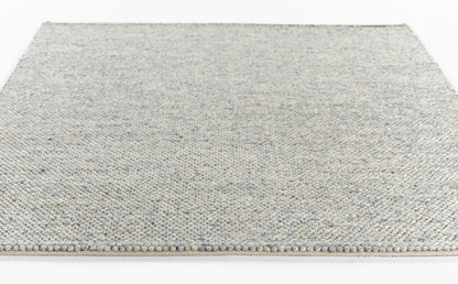 Rectangular blue-gray speckled flatwoven rug with beige fringe.