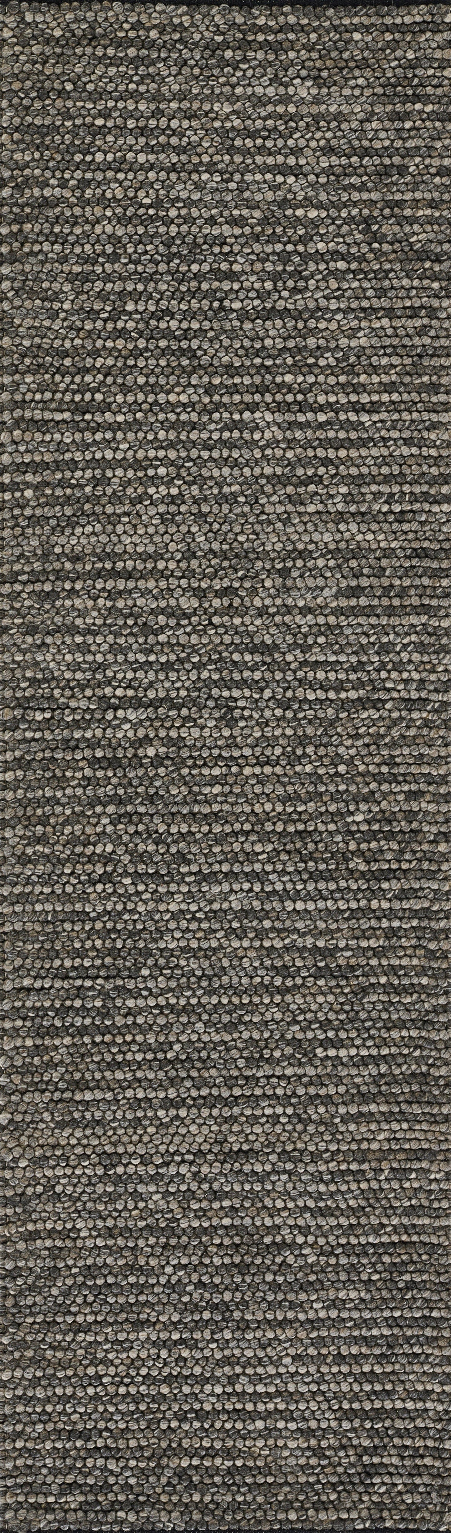 Close-up of neutral beige-brown woven rug texture with speckled fibers; rustic tweed style, ideal for living area.