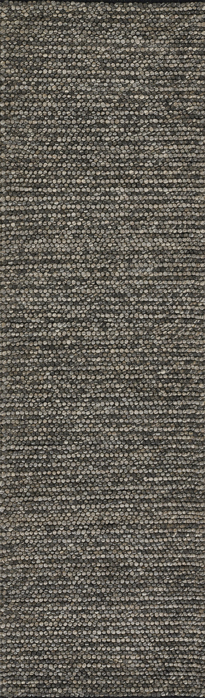 Close-up of neutral beige-brown woven rug texture with speckled fibers; rustic tweed style, ideal for living area.
