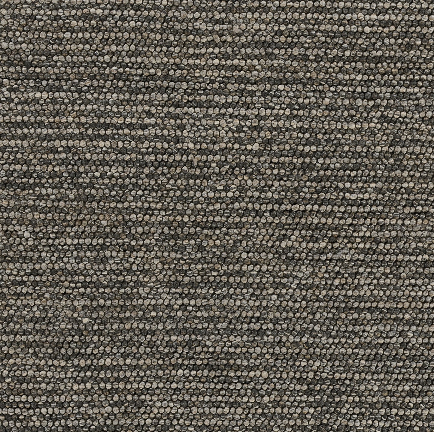 Beige-brown speckled textured rug with pebble loop pile and subtle chevron pattern.