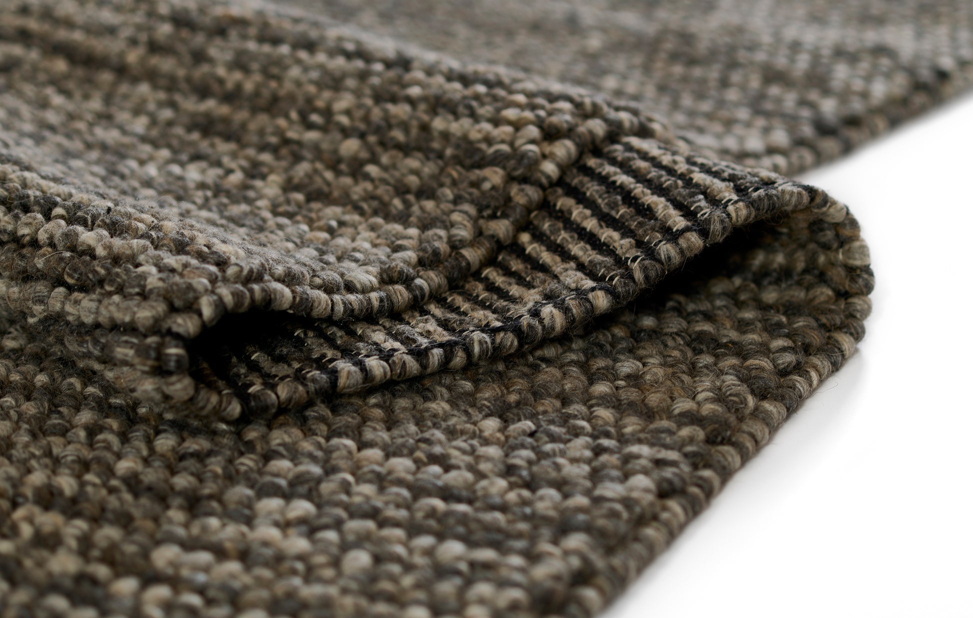 Taupe-gray boucle rug with chunky loop-pile texture, soft woven floor covering.