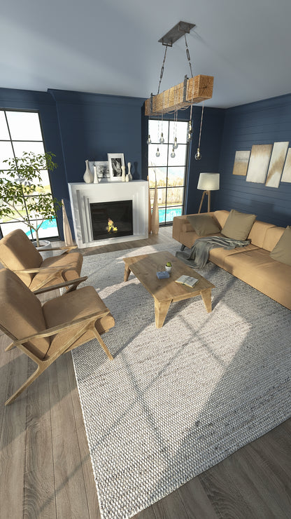 Cozy living room with navy walls, tan fabric sofas, wooden armchairs, beige textured rug, pine coffee table and a lit fireplace.