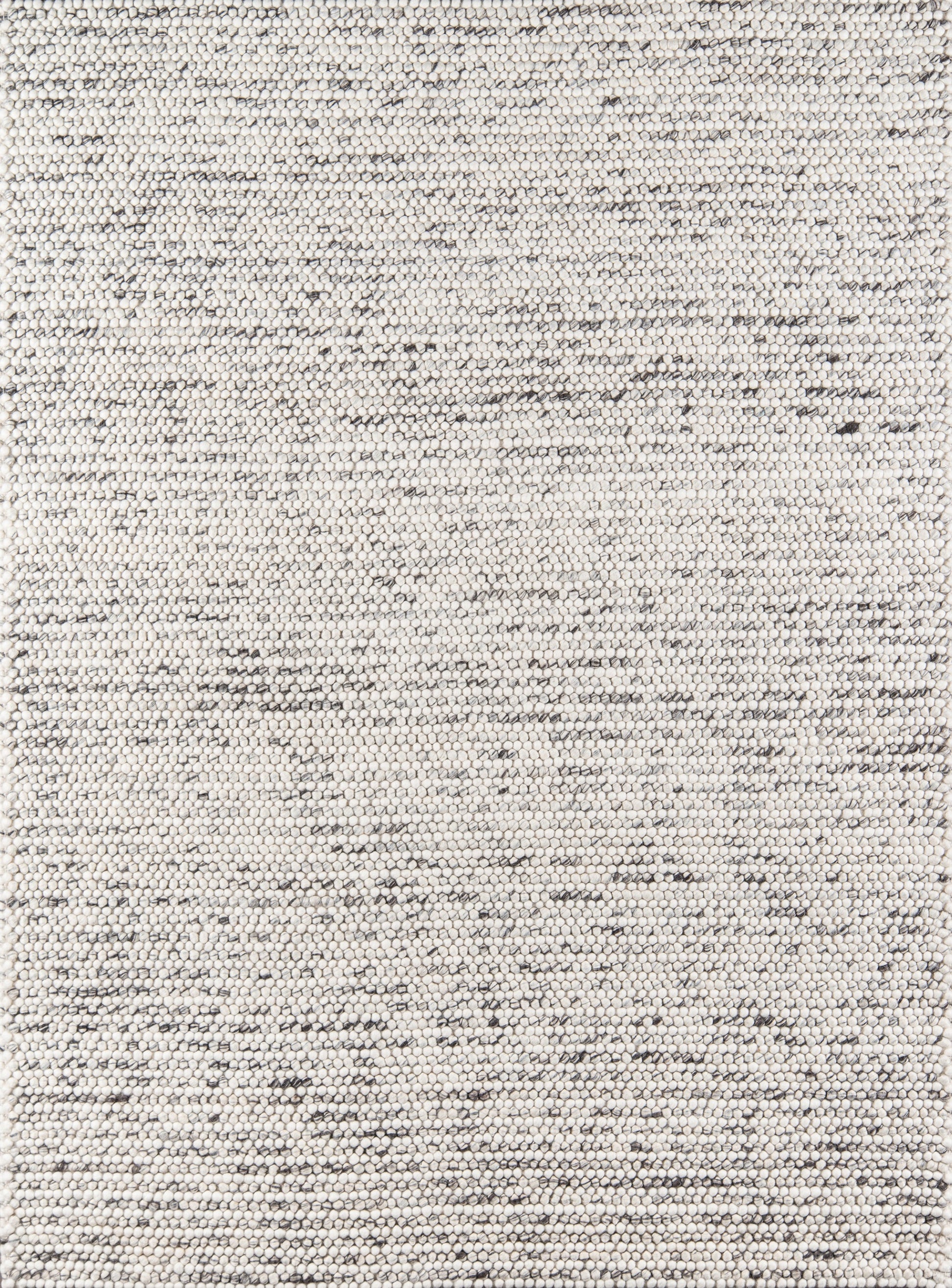 Close-up of a light beige woven rug texture with subtle gray flecks; flat-weave, versatile floor covering.