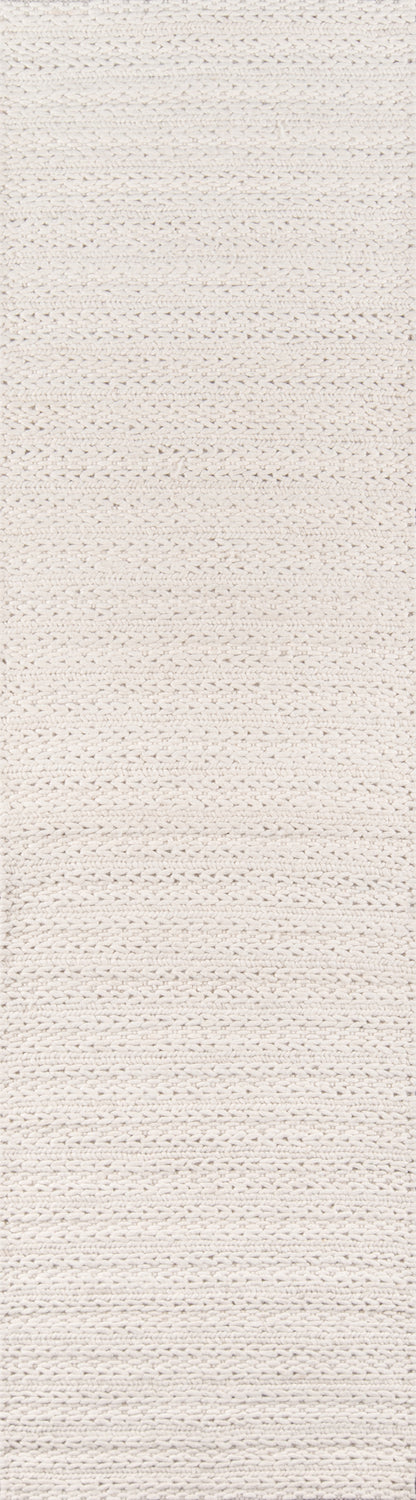 Ivory chunky knitted rug with horizontal ribbed weave and soft textured surface.
