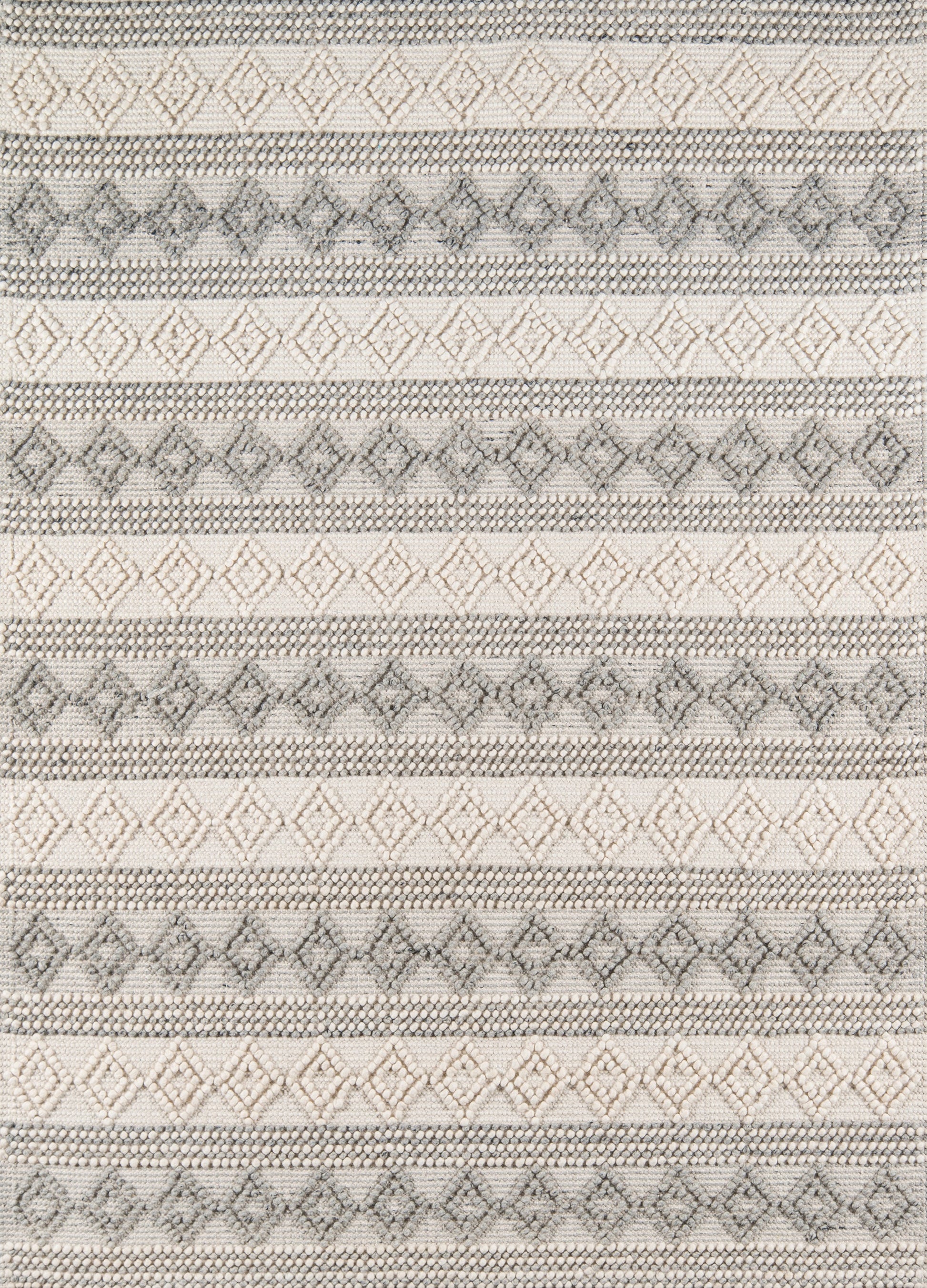 Ivory-gray woven rug with repeating diamond motifs and dotted stripes in a geometric boho style.
