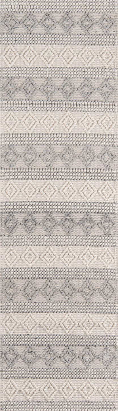 Ivory and gray woven rug with repeating diamond and stripe geometric motifs; neutral Nordic-inspired decor.