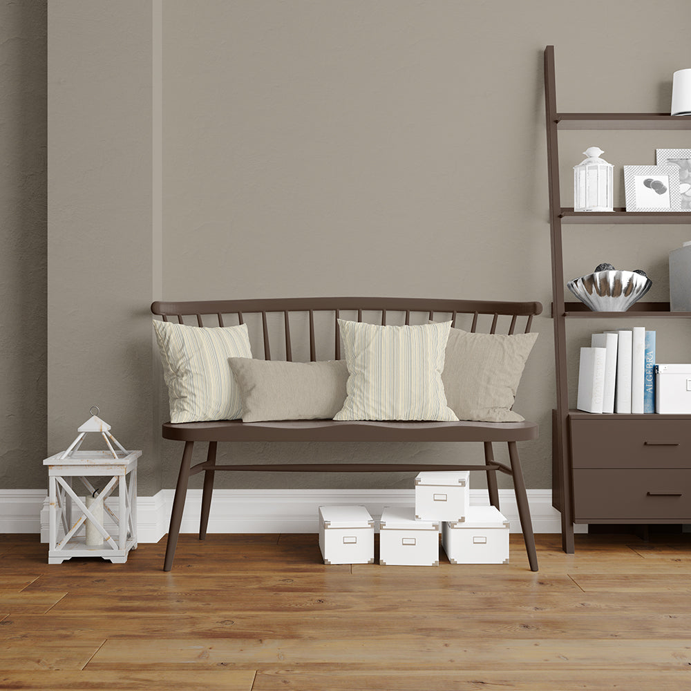 Dark brown wooden spindle-back bench with cream cushions in a taupe living room, featuring pearl stripe textured fabric upholstery.