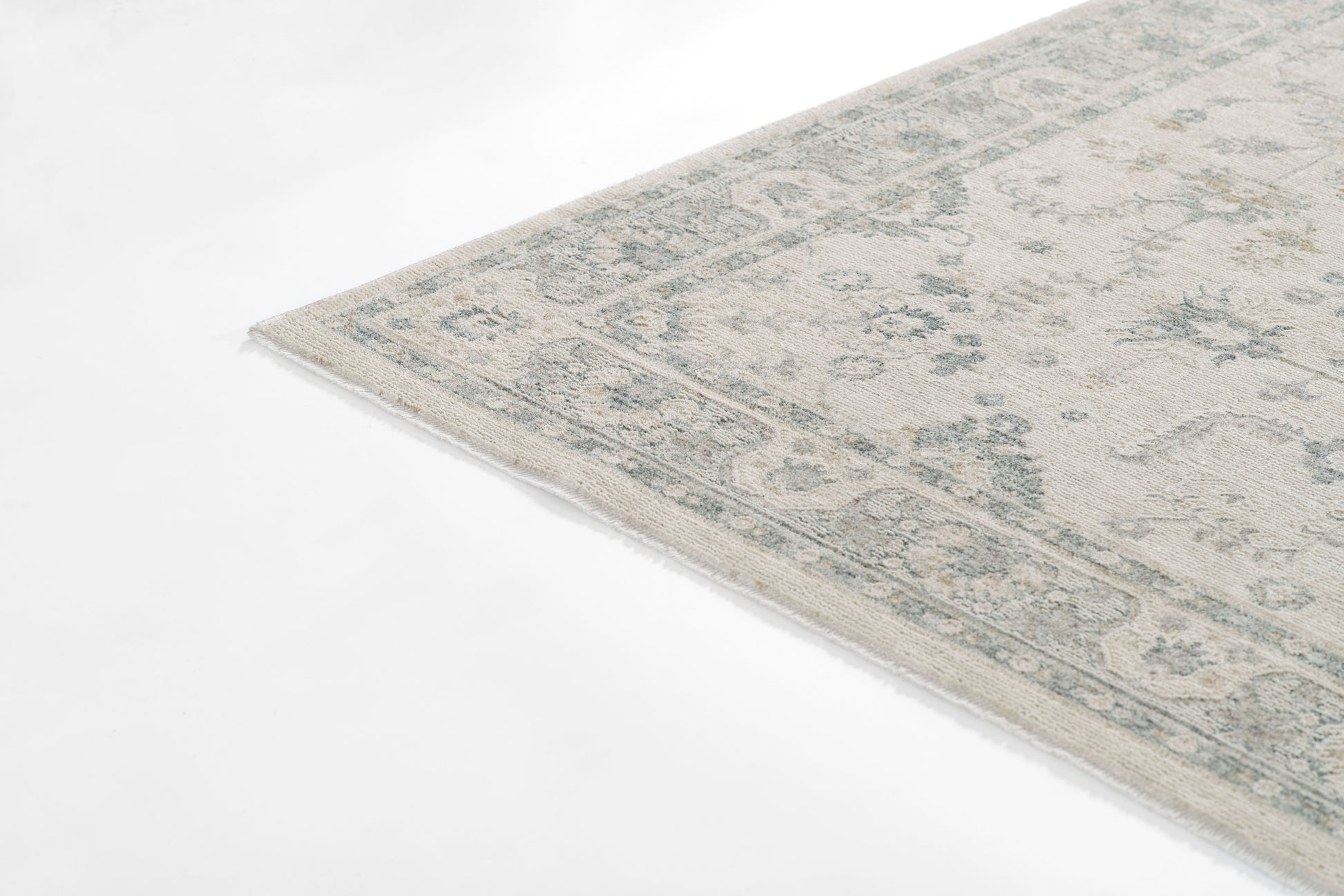 Rectangular pale blue & beige vintage-style Persian rug with a floral border.