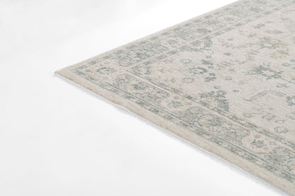 Rectangular pale blue & beige vintage-style Persian rug with a floral border.