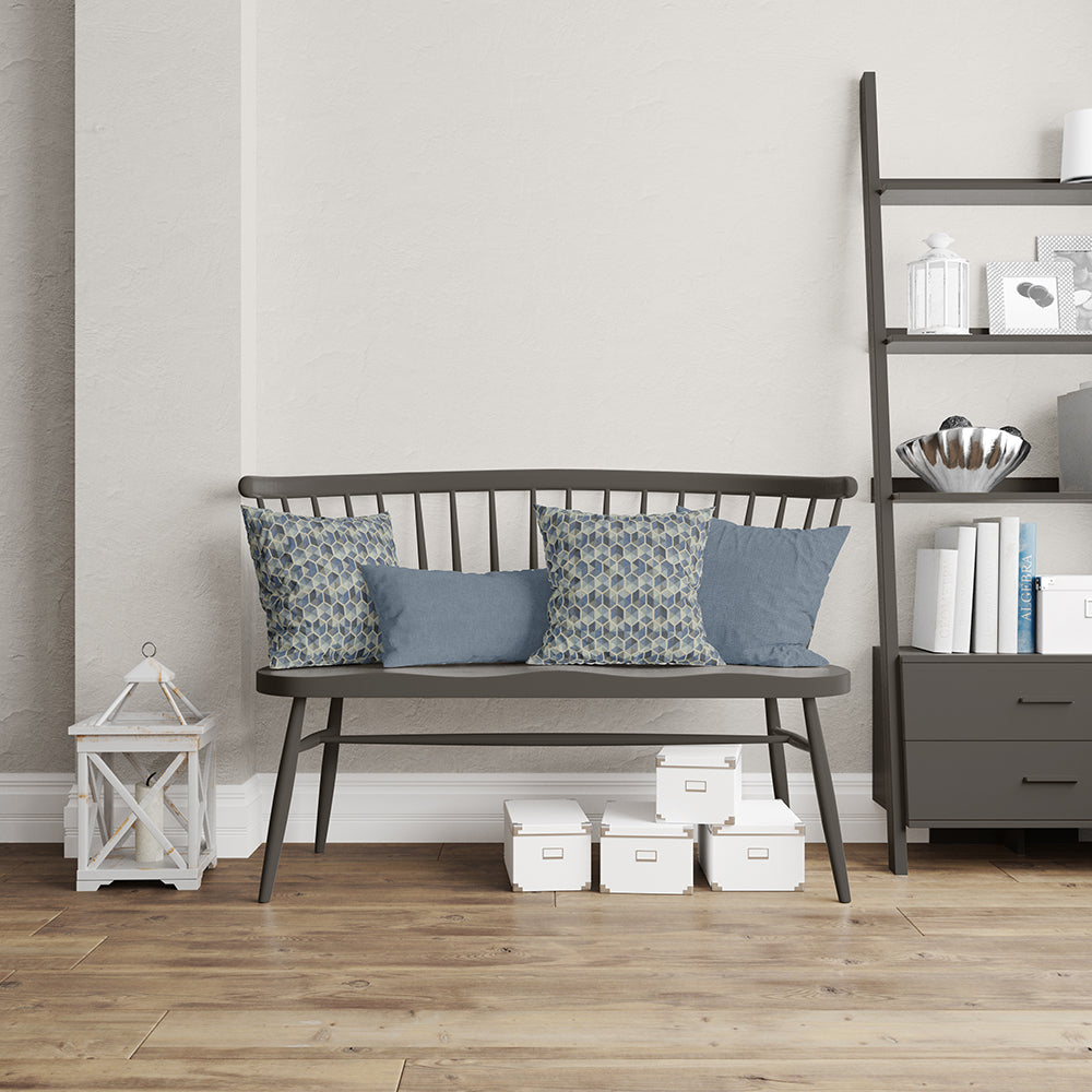 Blue geometric fabric with a glacier-inspired pattern in a transitional style, shown on cushions in a modern living room.