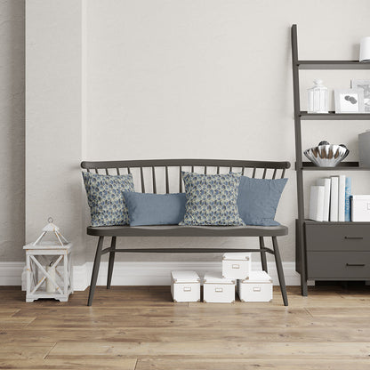 Blue geometric fabric with a glacier-inspired pattern in a transitional style, shown on cushions in a modern living room.