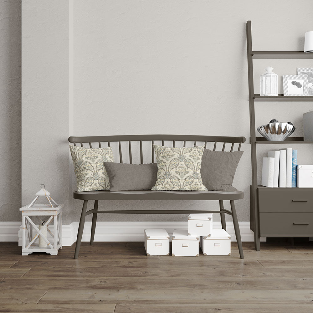 Dark metal-framed bench with a wooden slatted seat and floral and grey fabric upholstery on cushions in a modern neutral living room