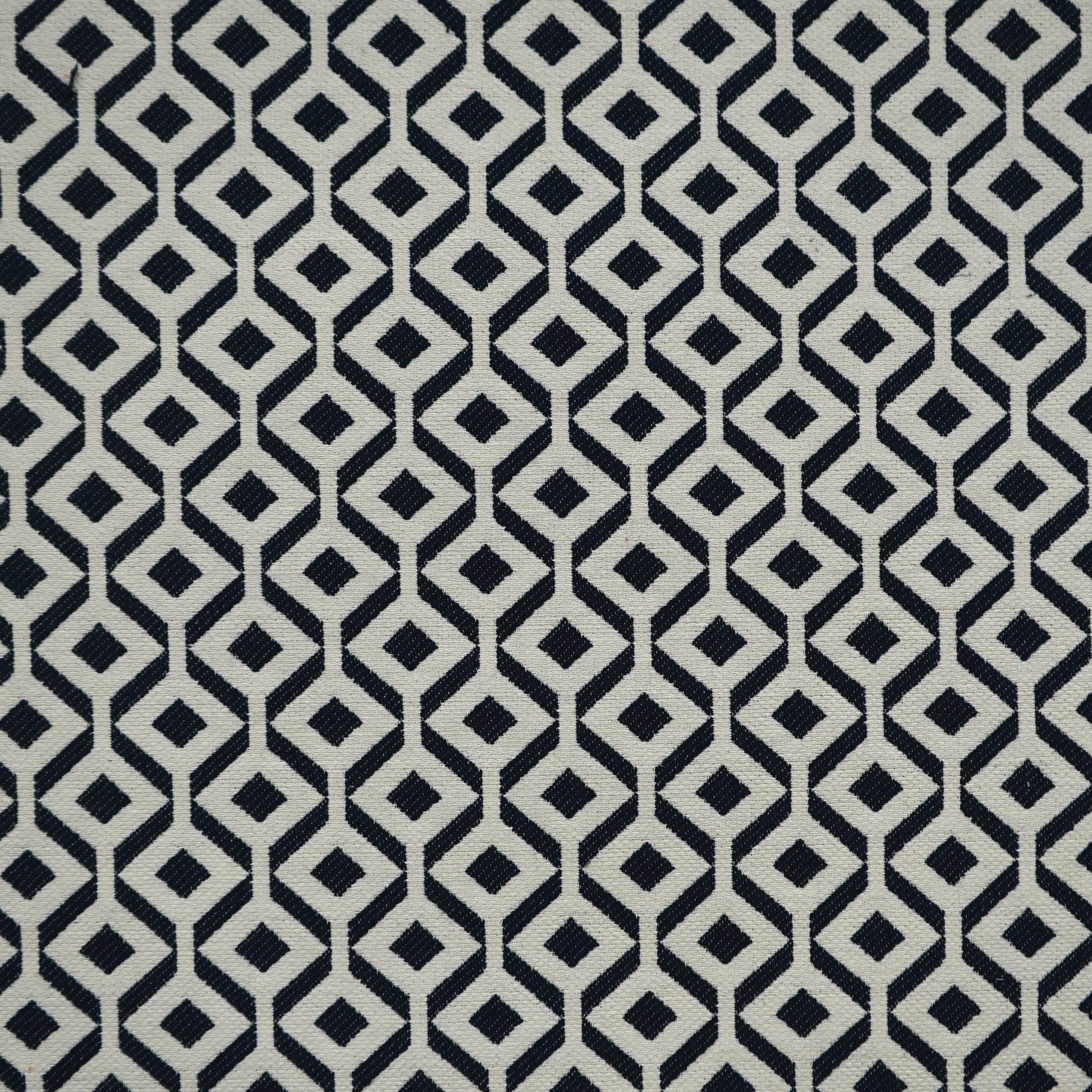 Navy and beige geometric diamond lattice on woven Jacquard fabric; modern upholstery and home-decor textile.