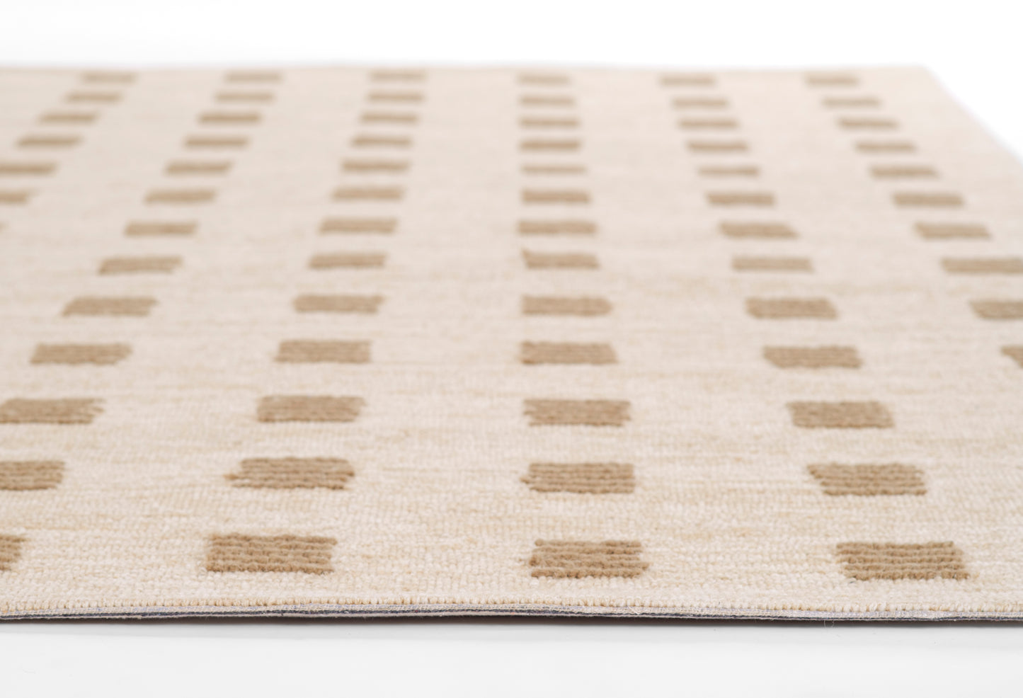 Beige flat-weave rug with evenly spaced light brown rectangular blocks in vertical rows; geometric, modern look.