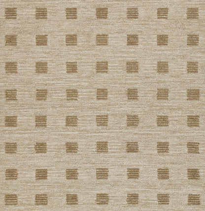 Beige textured area rug with a subtle grid of darker tan square blocks.
