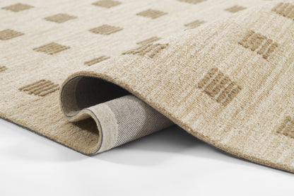 Beige woven area rug with light brown diamond pattern; rolled edge reveals gray backing & soft pile.