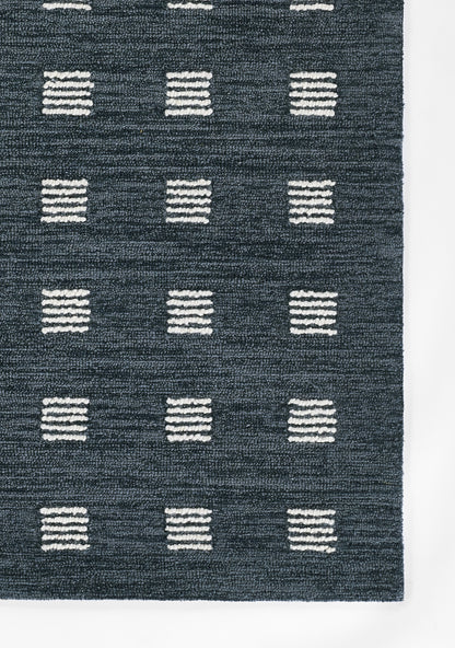 Dark blue rug with white striped squares arranged in a grid pattern.