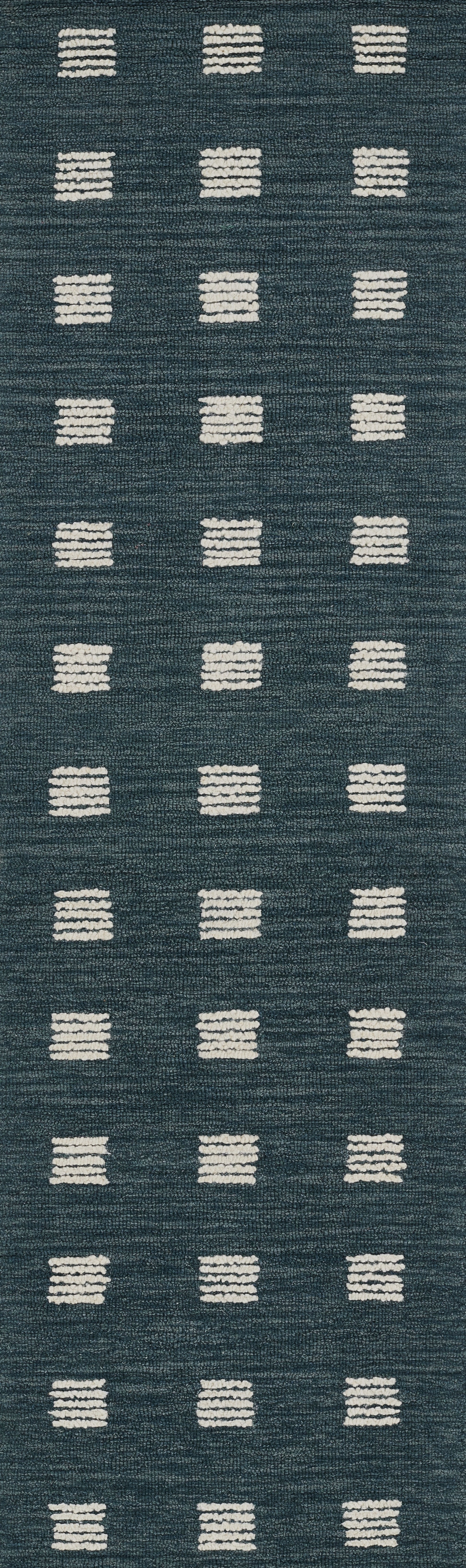 Blue woven rug with white rectangular tufted dots in a neat grid pattern.