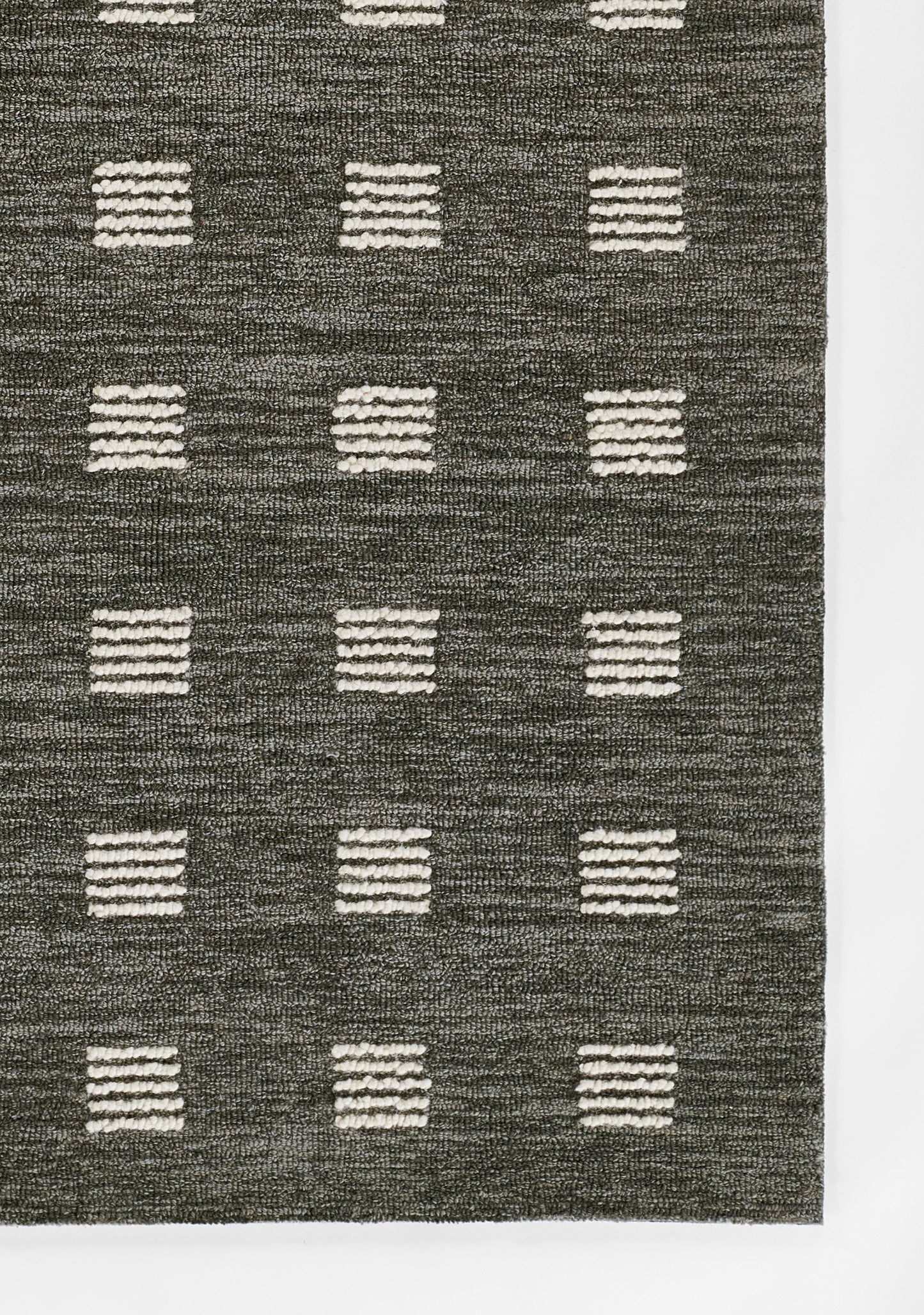 Charcoal rug with white striped squares in a regular grid; textured woven pile.