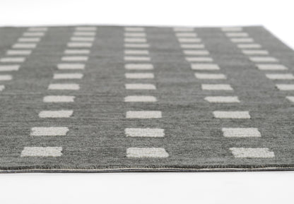 Gray area rug with white rectangular blocks in vertical columns, modern geometric design
