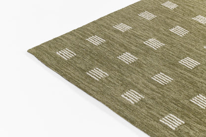 Olive green flat-weave rug with white stitched square blocks in a grid pattern.