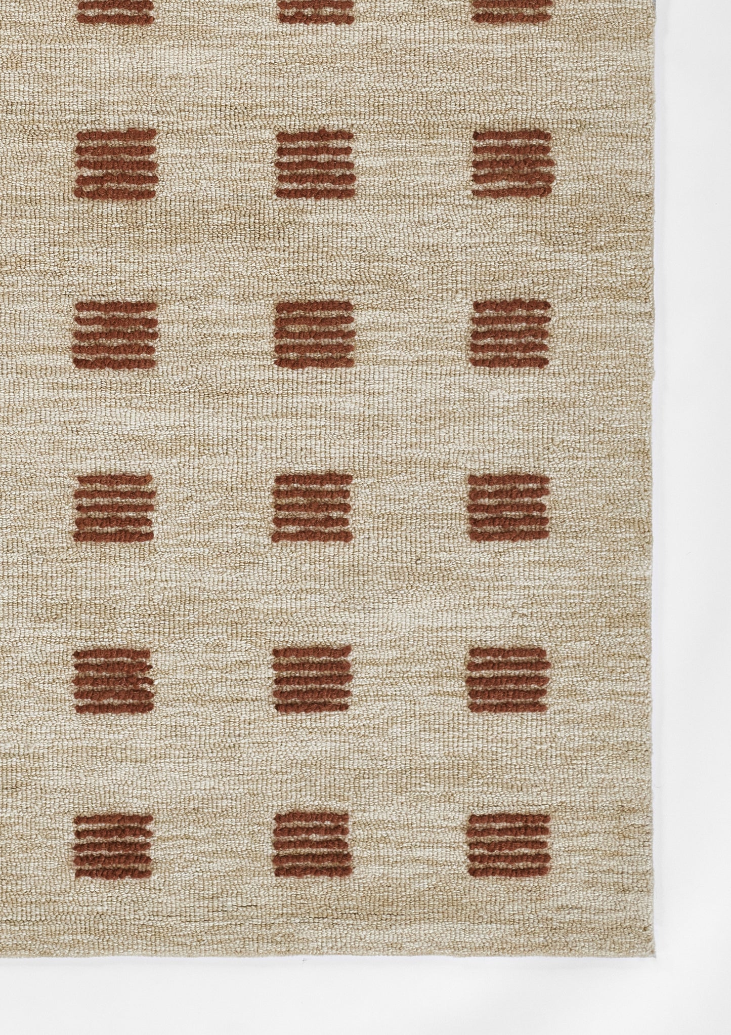 Beige woven rug with rust brown square tufted blocks arranged in a grid; textured natural fiber.