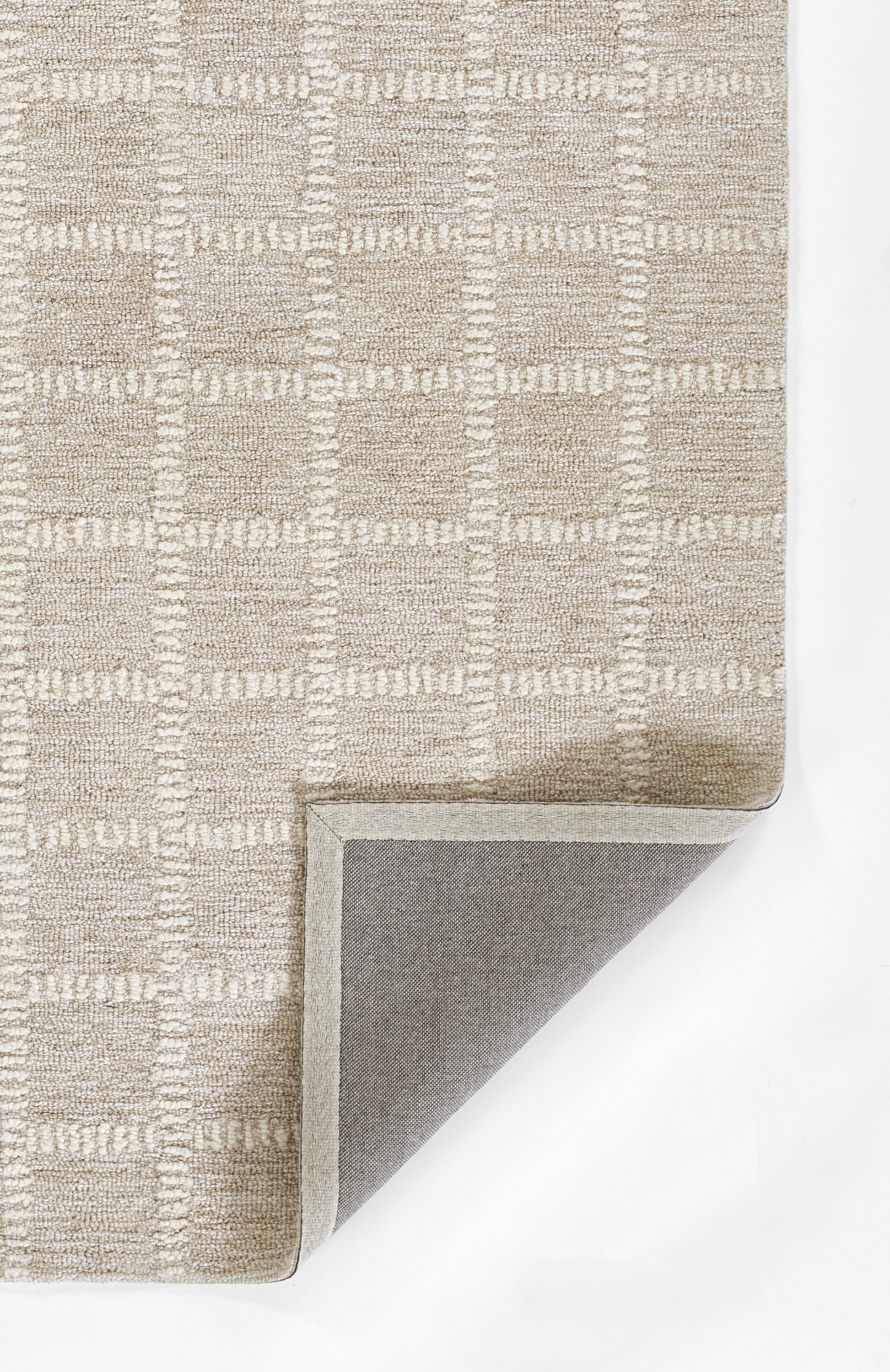 Beige textured area rug with a subtle checkered pattern, looped pile, bound edges; grey underside peeks at corner.