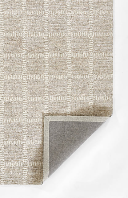 Beige textured area rug with a subtle square grid pattern; folded corner reveals grey underside and light binding.
