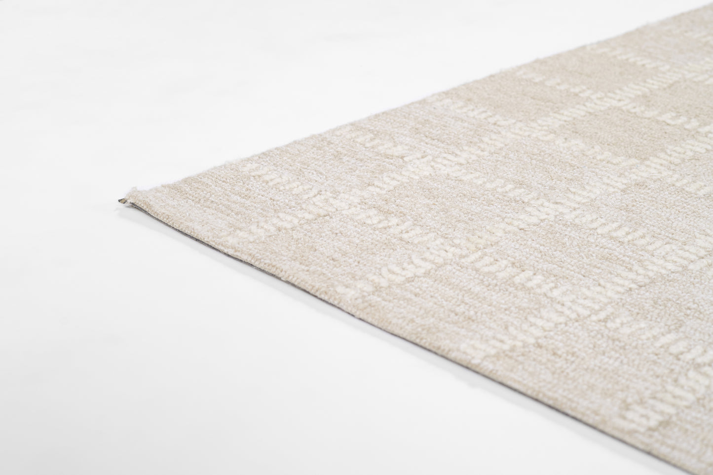 Beige boucle-style rectangular area rug with soft textured pile and subtle geometric pattern.