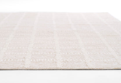 Beige low-pile area rug with subtle tonal grid; soft cream hues, rectangular shape for living room or bedroom.