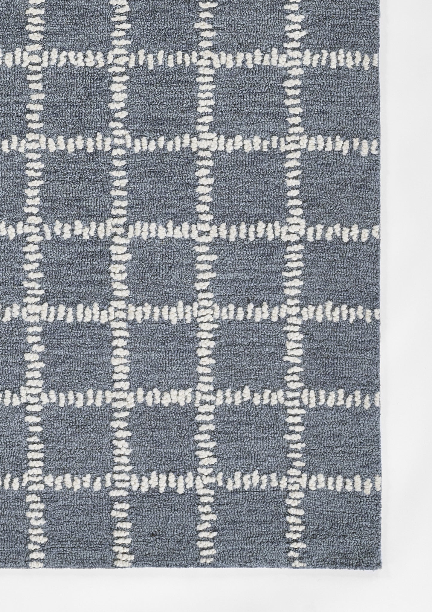 Blue textured area rug with a white dashed grid pattern in plush loop-pile.