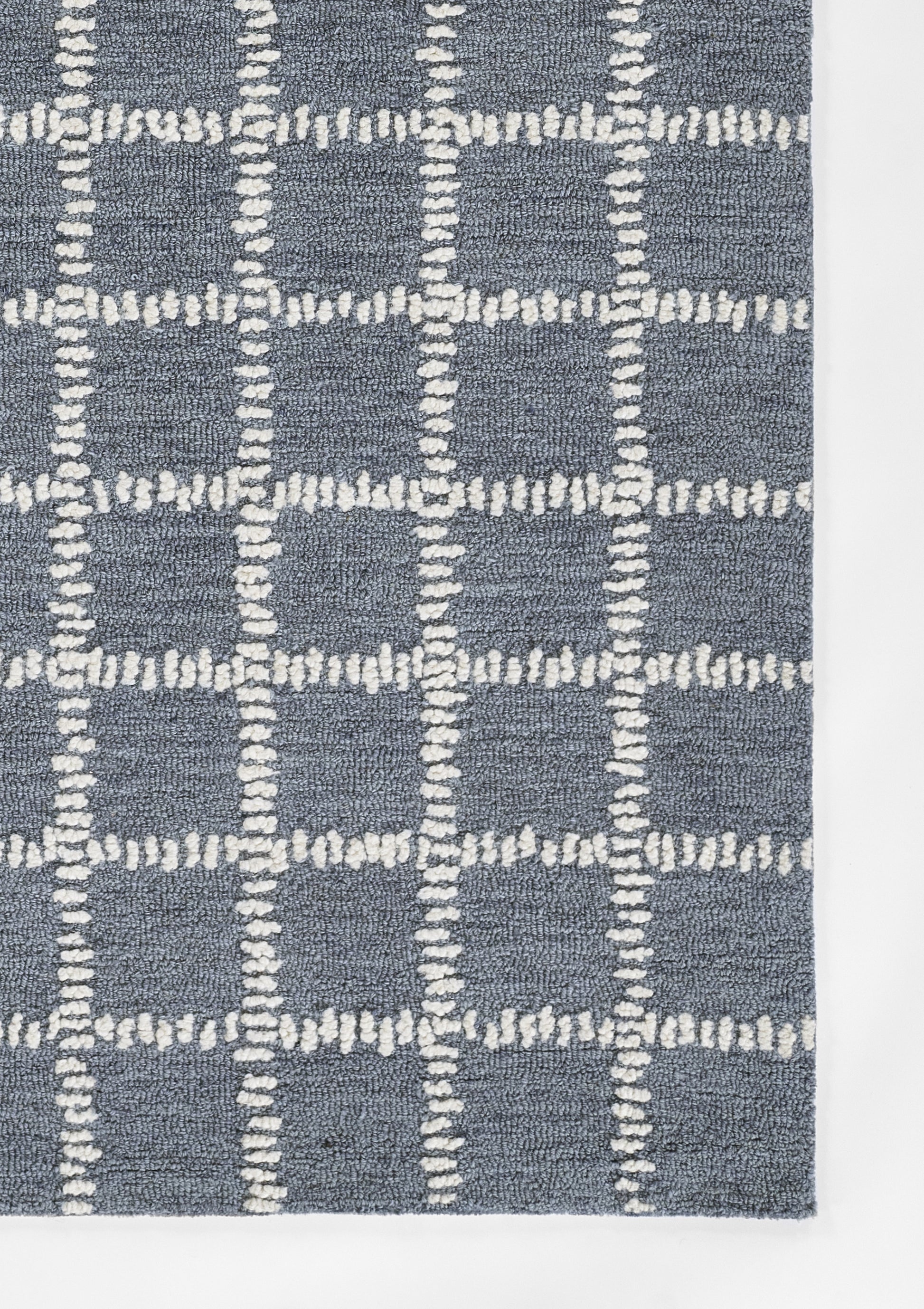 Blue textured area rug with a white dashed grid pattern in plush loop-pile.
