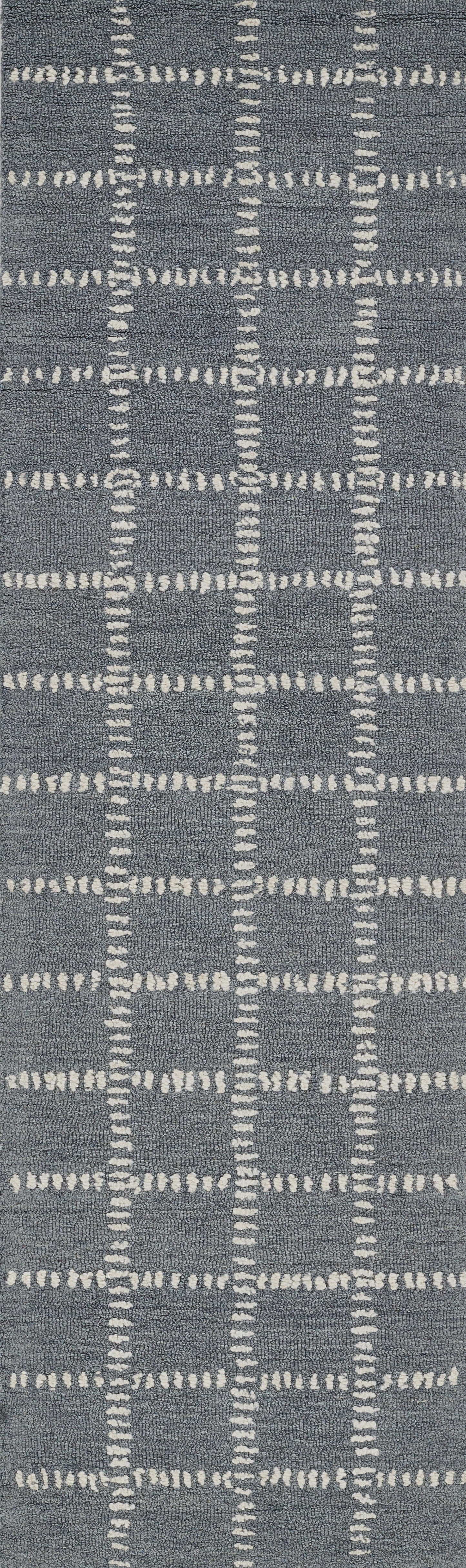 Blue-gray rug with white dashed grid lines forming a geometric plaid pattern.