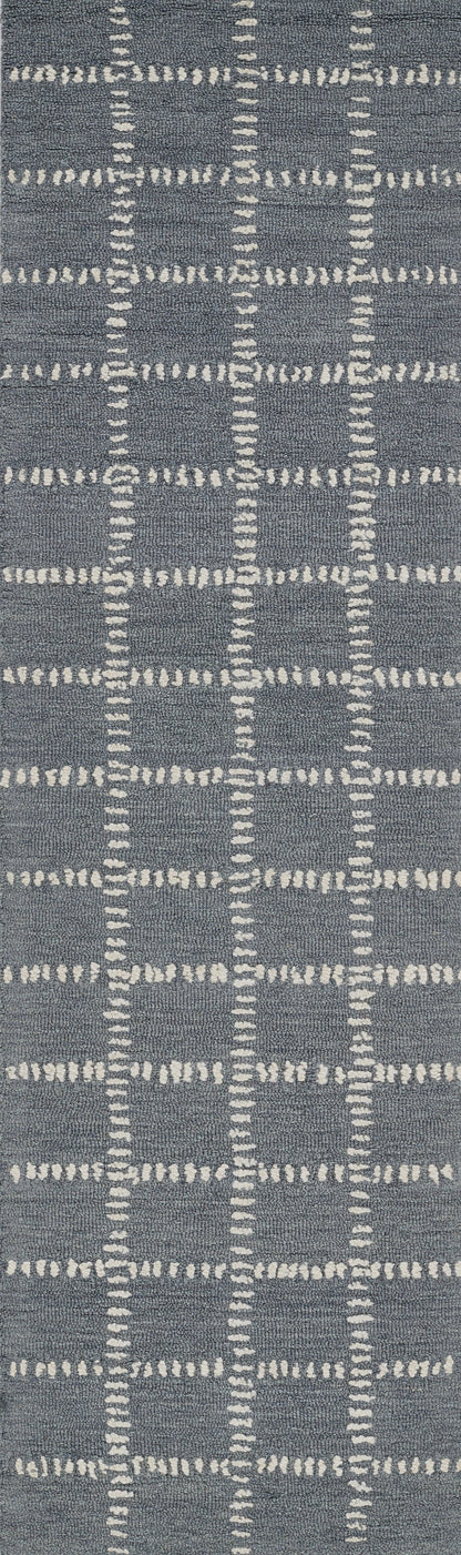 Blue-gray rug with white dashed grid lines forming a geometric plaid pattern.