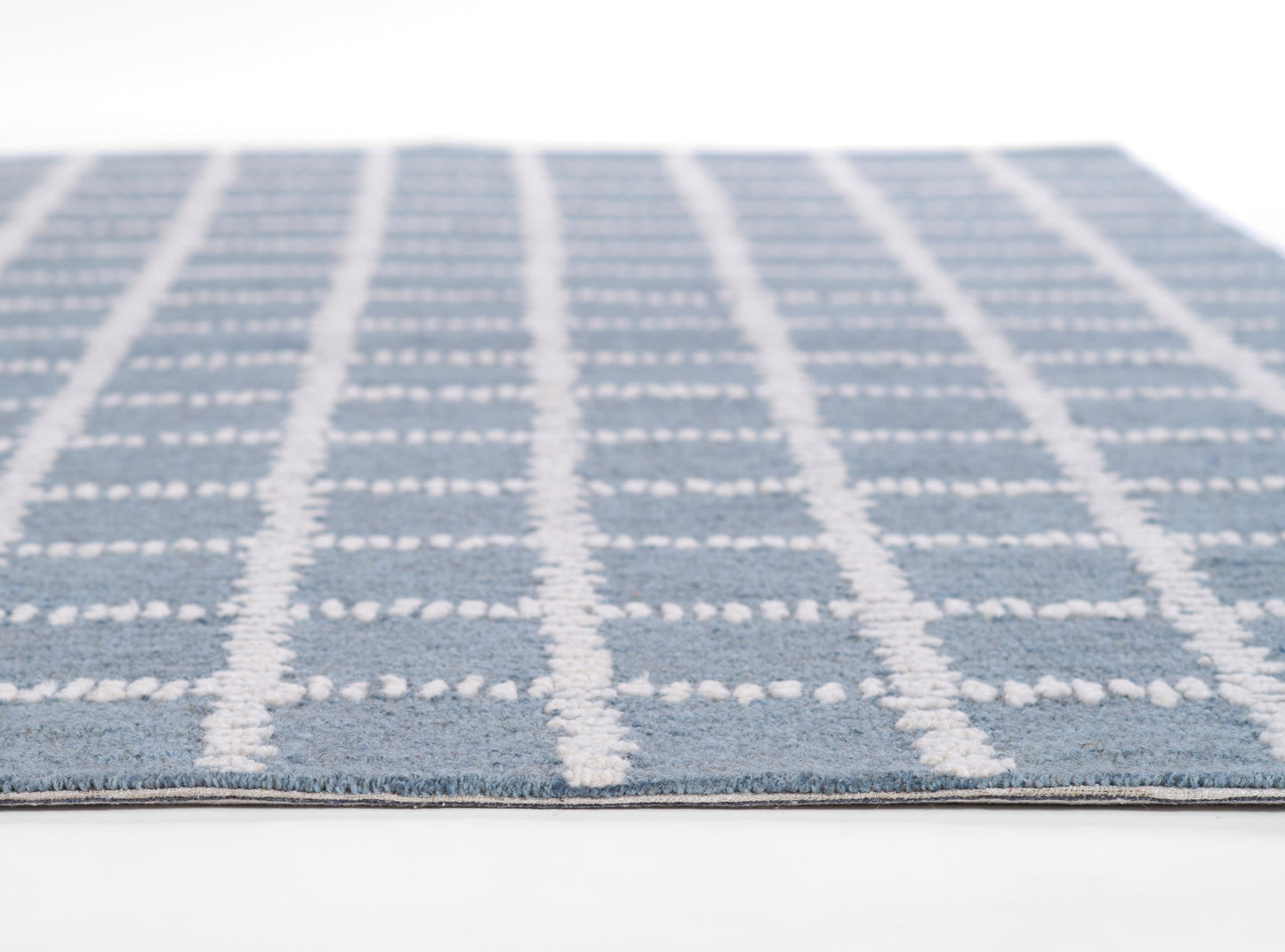 Blue rug with white vertical & horizontal grid lines in a soft textured weave; rectangular, modern plaid style.