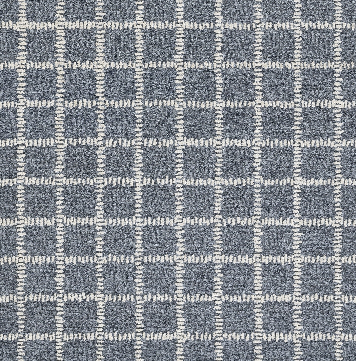 Blue-gray woven rug with white stitched grid squares in a modern geometric pattern.