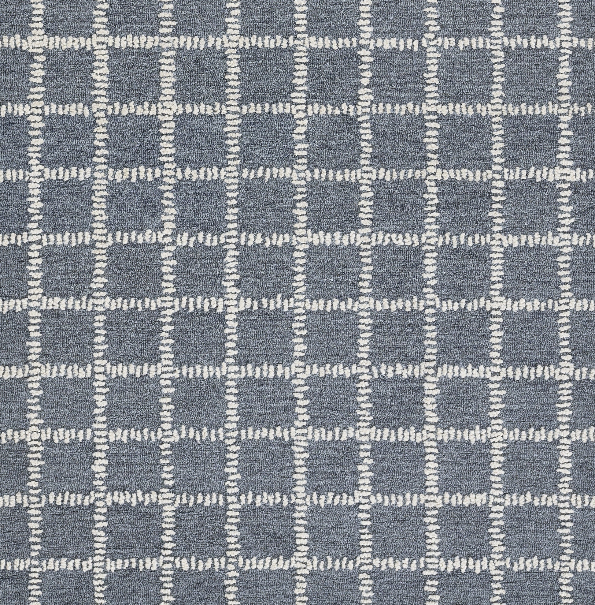 Blue-gray woven rug with white stitched grid squares in a modern geometric pattern.