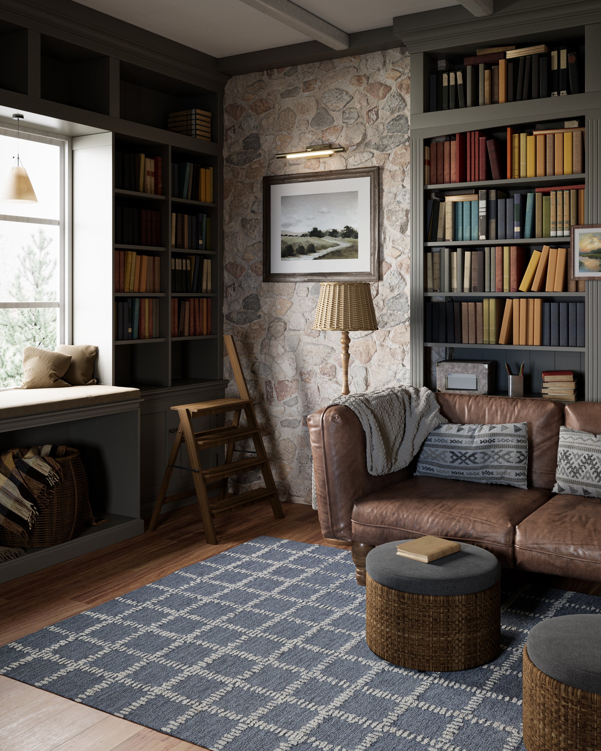 Cozy library living room with dark built-in bookshelves, stone wall, brown leather sofa, blue rug, wicker ottomans.