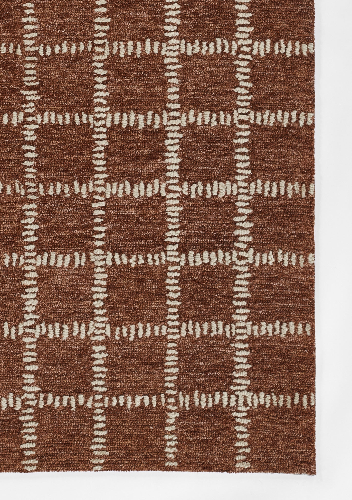 Brown textured shag rug with white stitched grid forming square patterns, cozy decorative piece.