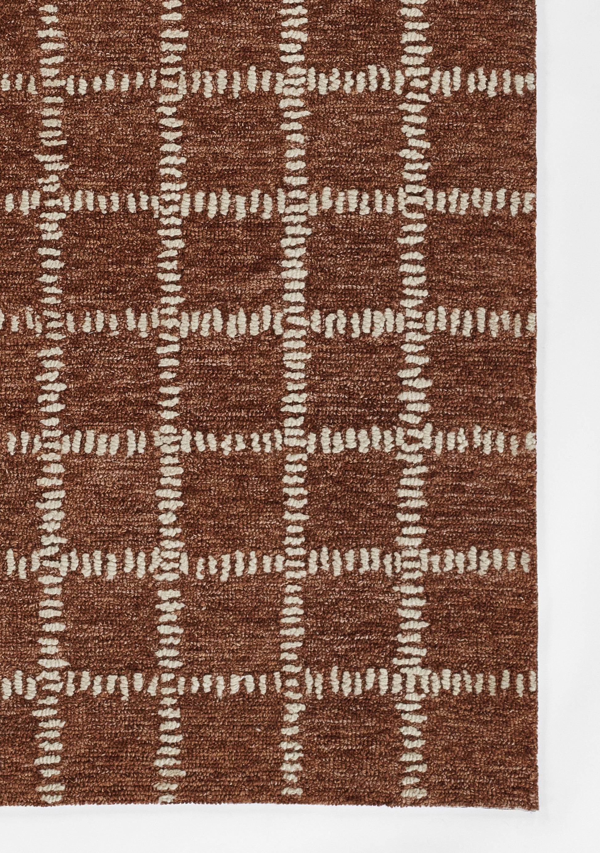 Brown textured shag rug with white stitched grid forming square patterns, cozy decorative piece.