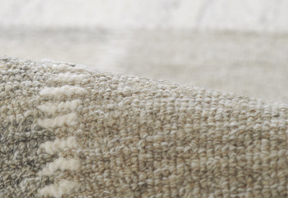 Close-up of a gray-beige woven rug with a chunky loop pile, soft neutral texture for living room decor.